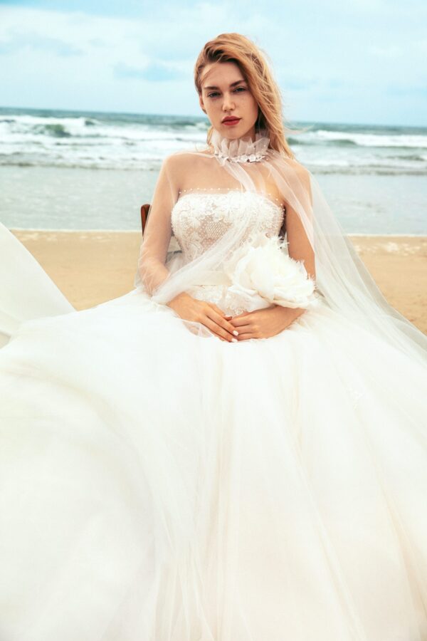 Strapless lace wedding gown with a sweetheart bodice, flowing tulle skirt, and sheer veil