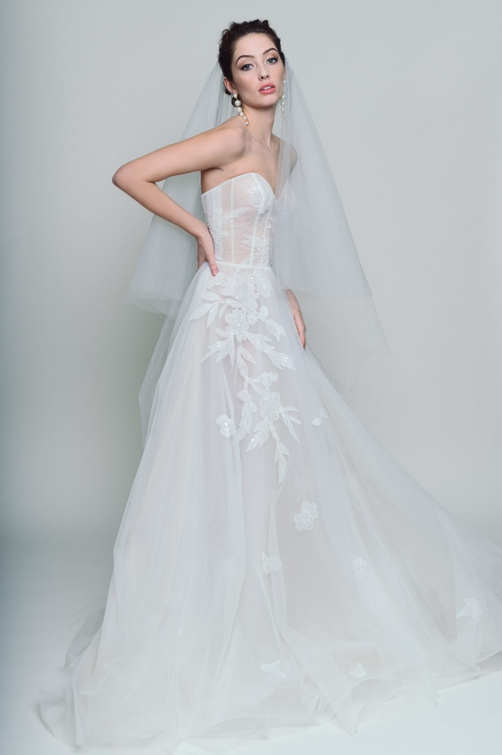 Ethereal strapless A-line wedding dress with a lace bodice and flowing OFF WHITE tulle skirt, perfect for a romantic wedding.