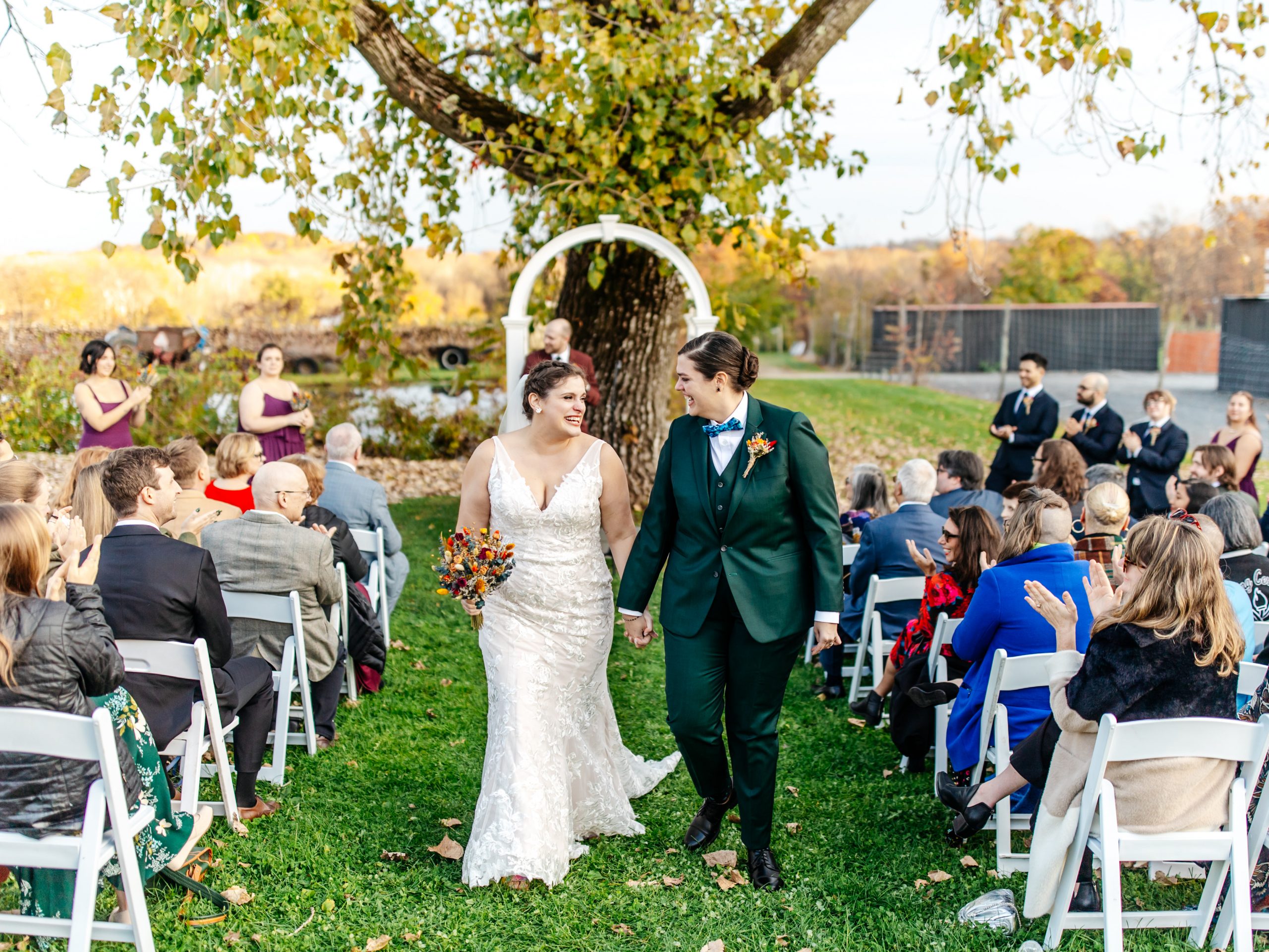 Beautiful queer couple wearing custom made wedding dresses