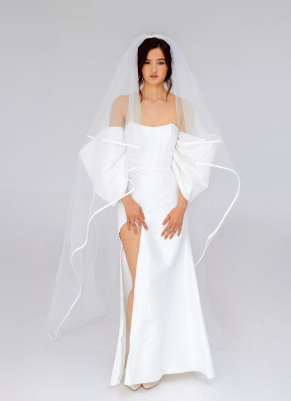 Elegant strapless mermaid wedding dress with detachable sleeves and high slit, perfect for modern brides